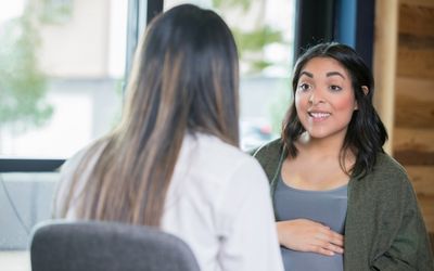 health consultation with pregnant woman and midwife